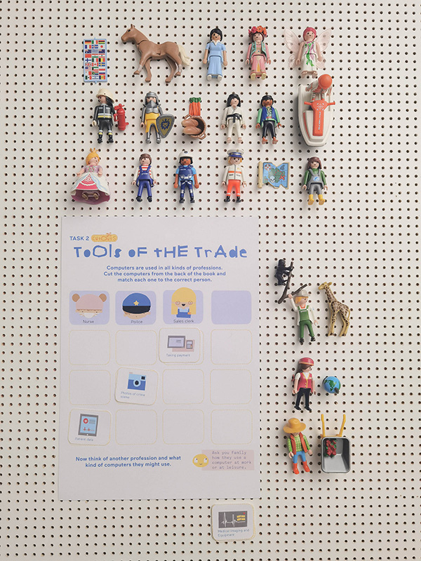 Hello Ruby activity page showing Tools of the Trade task with toy characters and cutout pieces arranged on pegboard